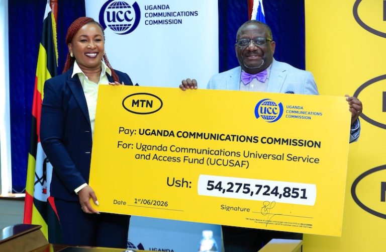 202606Sylvia-Mulinge-hands-over-a-dummy-cheque-to-William-Thembo