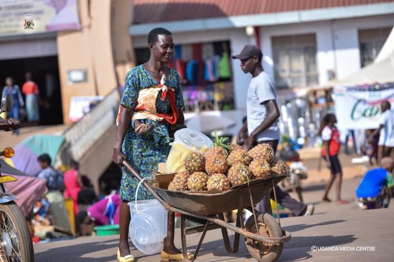 202607Woman-pushing-wheelbarrow-with-pineapples